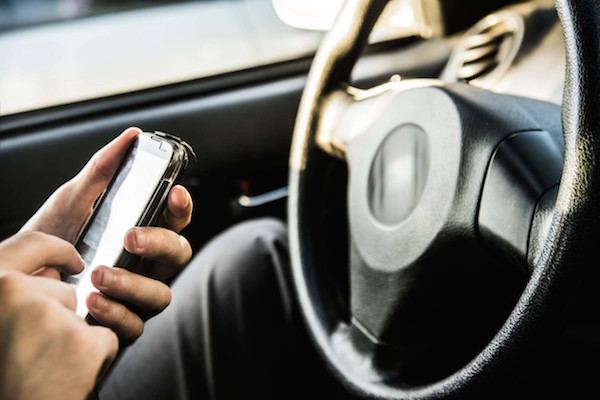 a driver texting while driving on a Georgia road