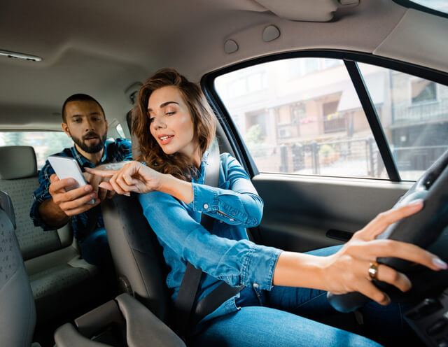 A Lyft driver in Georgia gets directions from a passenger.