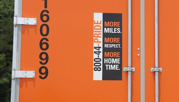 Sign on the rear of a tractor trailer advertising for hiring