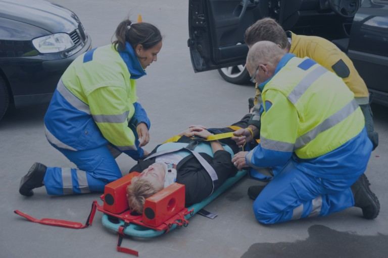 Georgia emergency medical technicians attending to accident victim