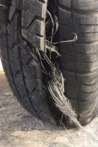image of a defective tire that has come apart