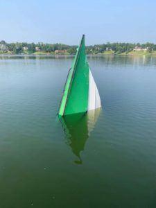 Submerge boat in the lake.