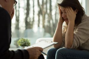 Terrified victim of rape in counseling session.