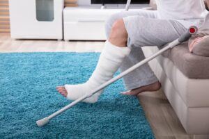 A person with an Injured leg with crutches due to slip and fall.