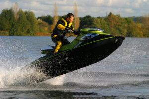 Jet ski rider leaping in open sea.