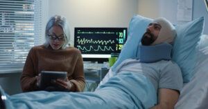 Brain injury patient with bandage resting at hospital ward.