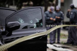 Bullet holes seen in the window of a car after an armed robbery shot.