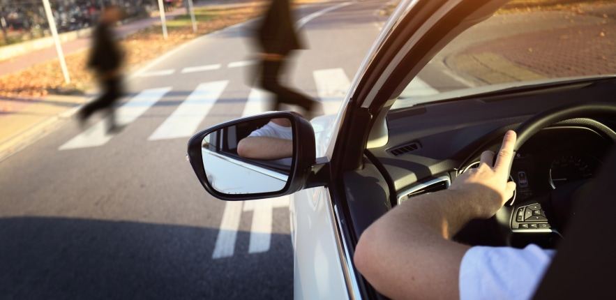Man driving towards pedestrian crossing