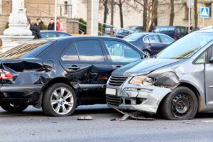 Two cars slide past each other in a collision at the highway.