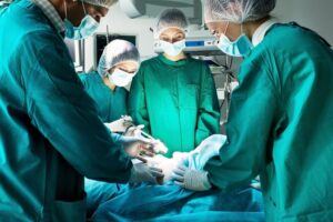 Team of doctors performing surgery in the operating room.