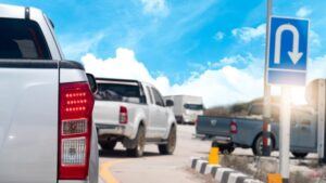 Rear side of pickup car stop and brake on the road waiting for another car to make a U-turn.